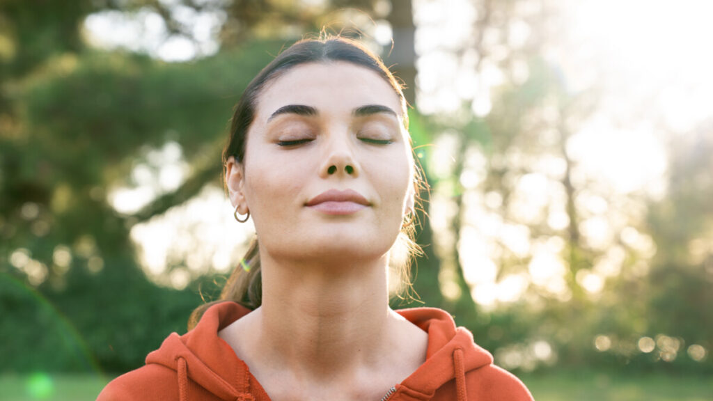 Relaxed woman breathing fresh air outdoors